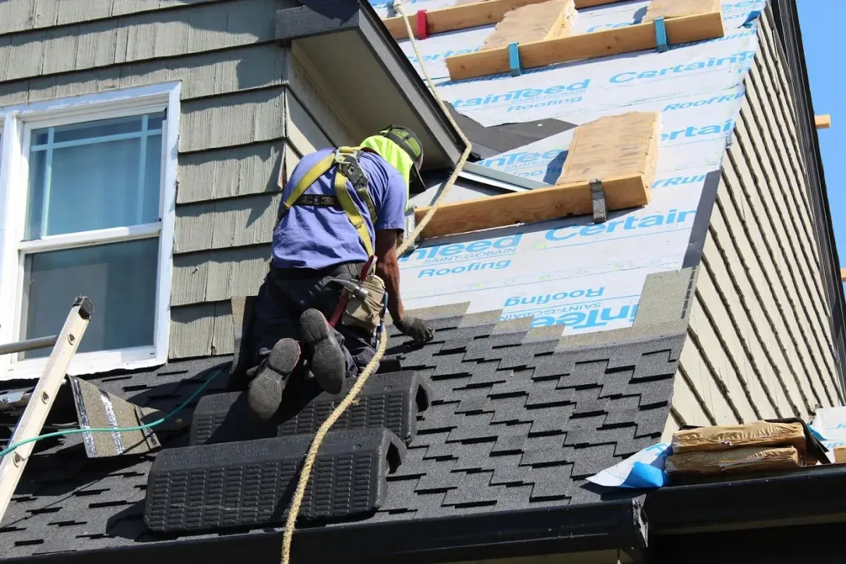Top roofing installation contractors finalizing clean shingles on an Essex County NJ home.