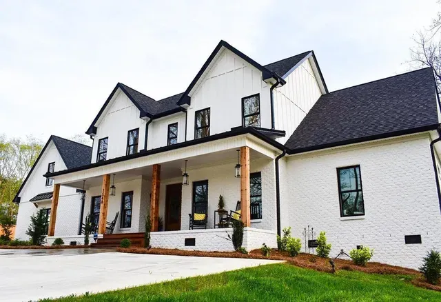 Expert roofing contractors installing new asphalt shingles on a home