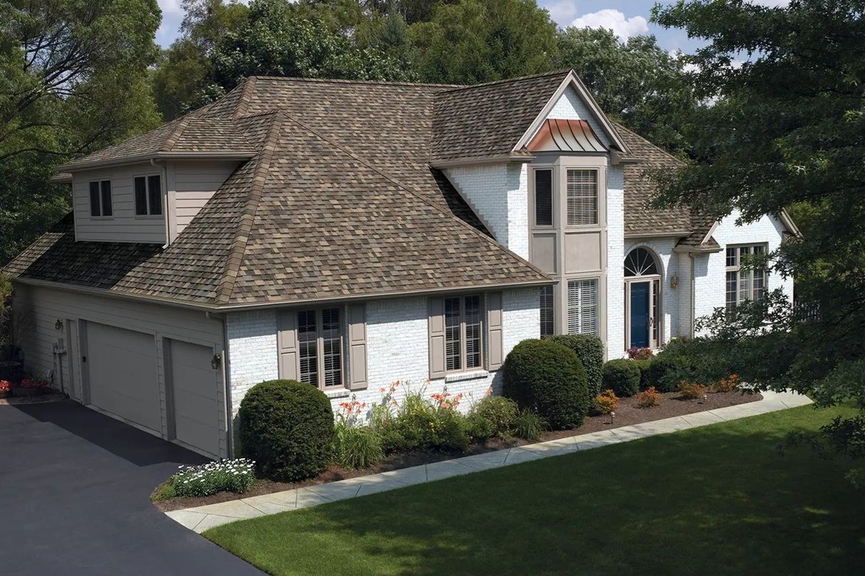 Professional roofing companies installing architectural asphalt shingles on a home in Butler, New Jersey.